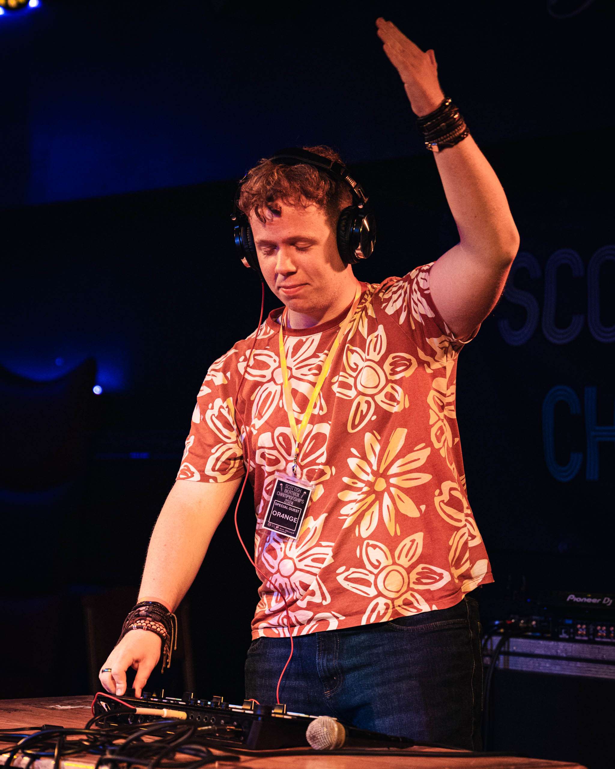 Sam Oren performing with headphones and music equipment